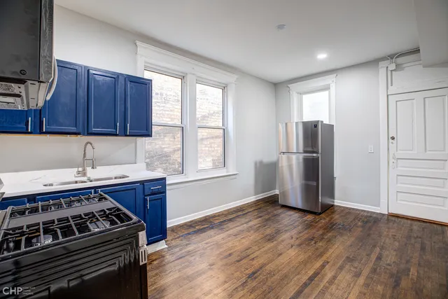 a kitchen with a stove a refrigerator and a sink
