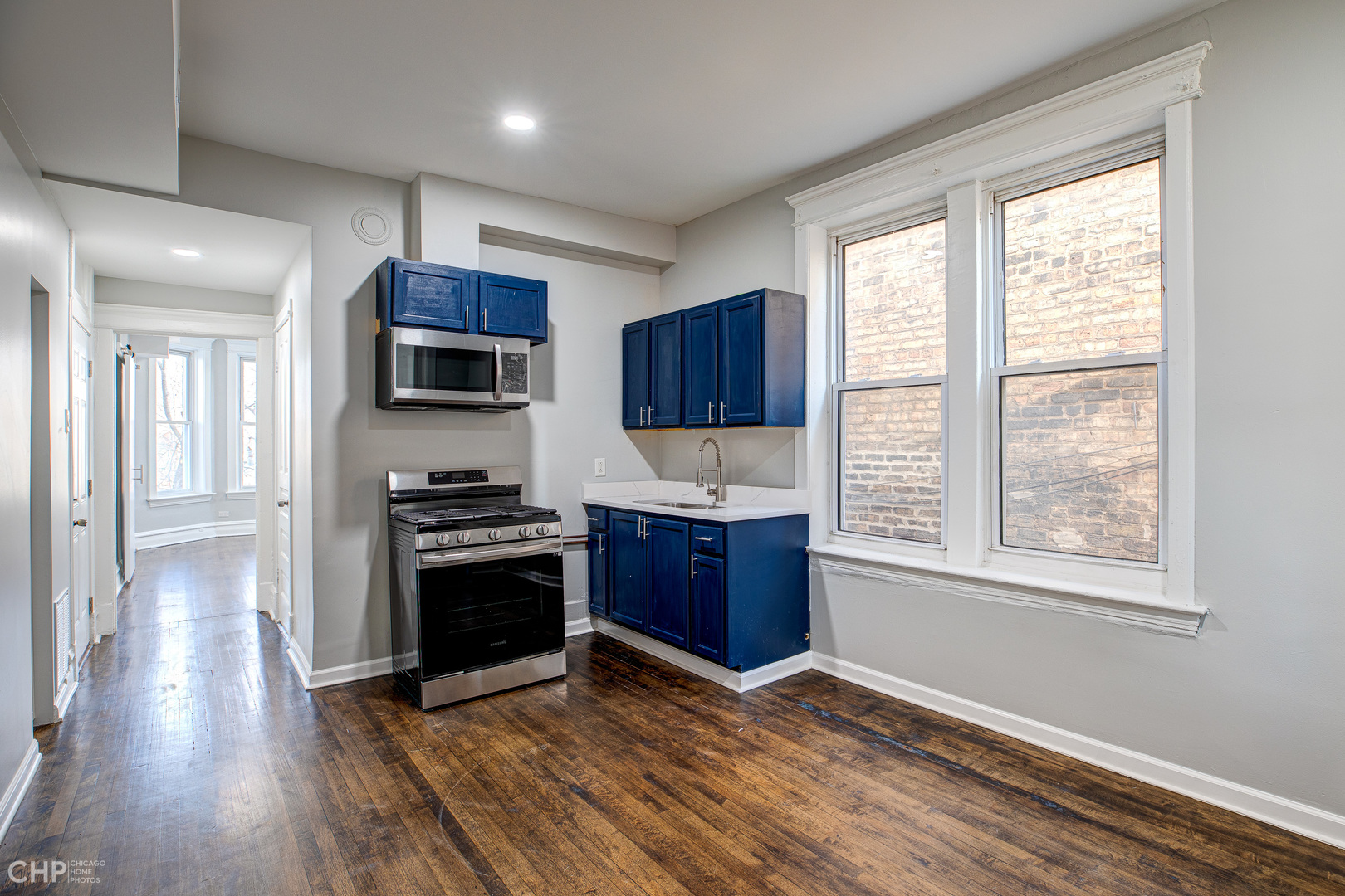 2623 West 21st Place Chicago, IL 60608 - Photo 25 of 29 a kitchen with stainless steel appliances granite countertop a stove a sink and a refrigerator