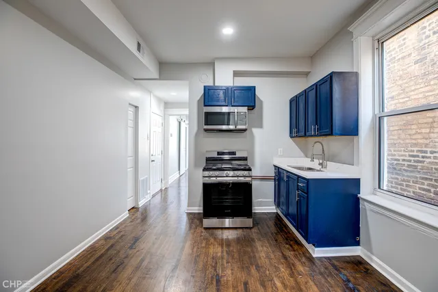 a kitchen with stainless steel appliances granite countertop a stove and a sink