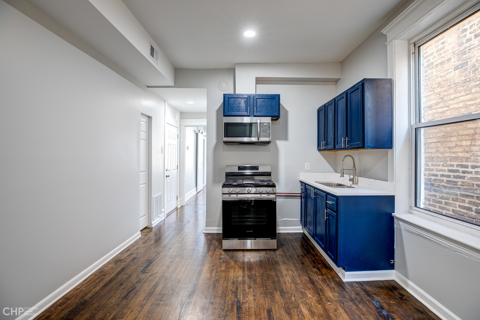 2623 West 21st Place Chicago, IL 60608 - Photo 26 of 29 a kitchen with stainless steel appliances granite countertop a stove and a sink