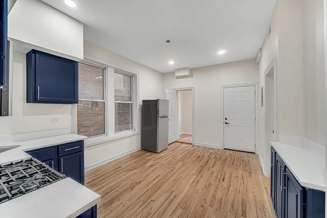a kitchen with stainless steel appliances granite countertop a refrigerator and a stove top oven