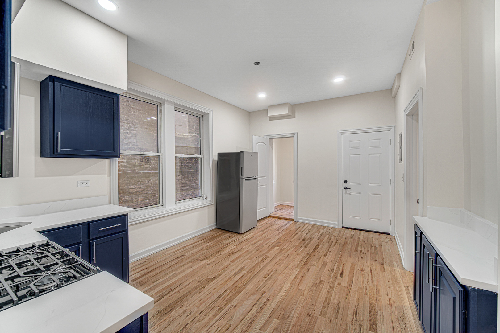 2623 West 21st Place Chicago, IL 60608 - Photo 10 of 29 a kitchen with stainless steel appliances granite countertop a refrigerator and a stove top oven