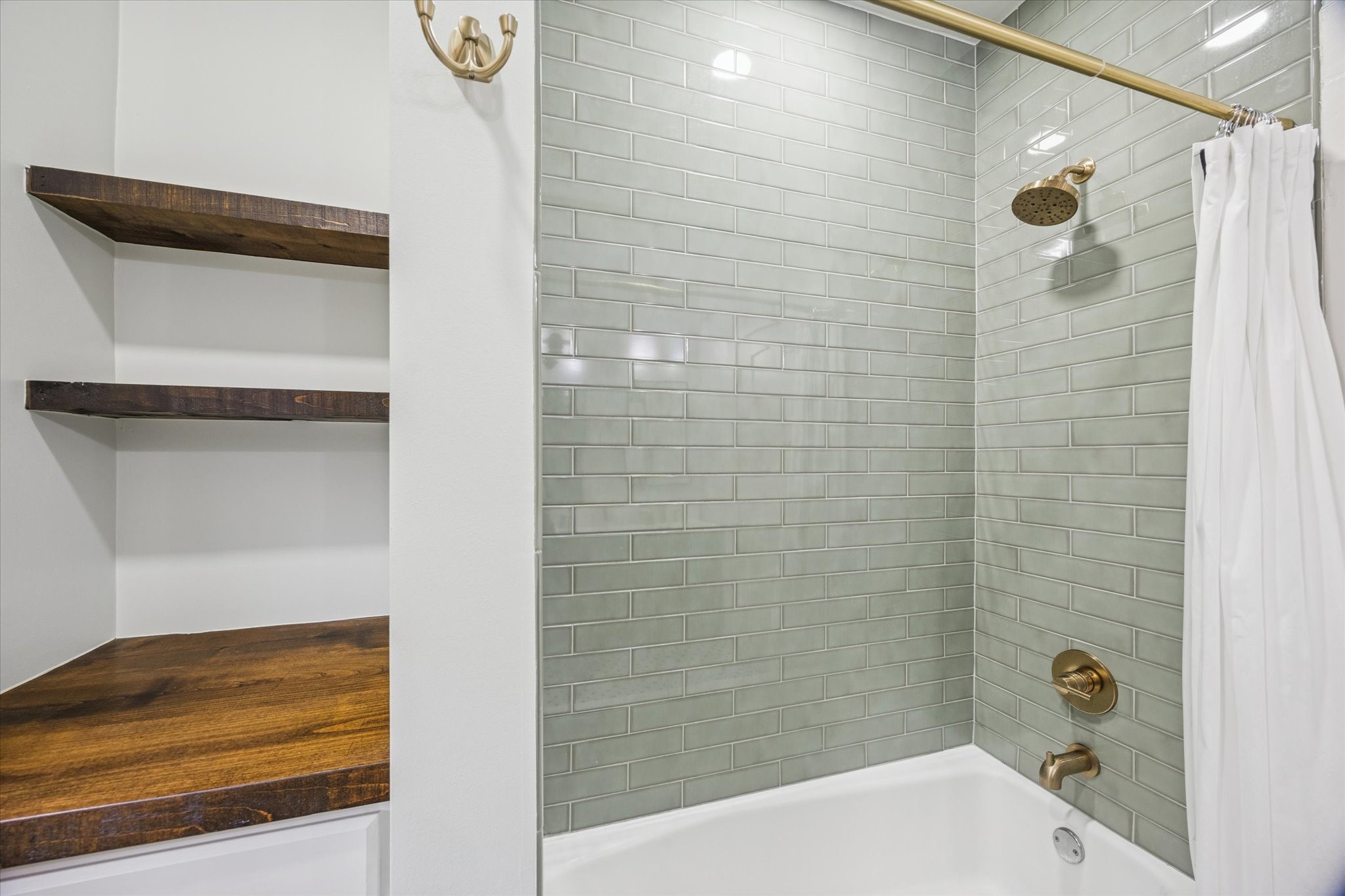1124 Dunbar Street Houston, TX 77009 - Photo 14 of 21 Green subway tile completes the shower/bath combo. Linen shelves line this wall as well