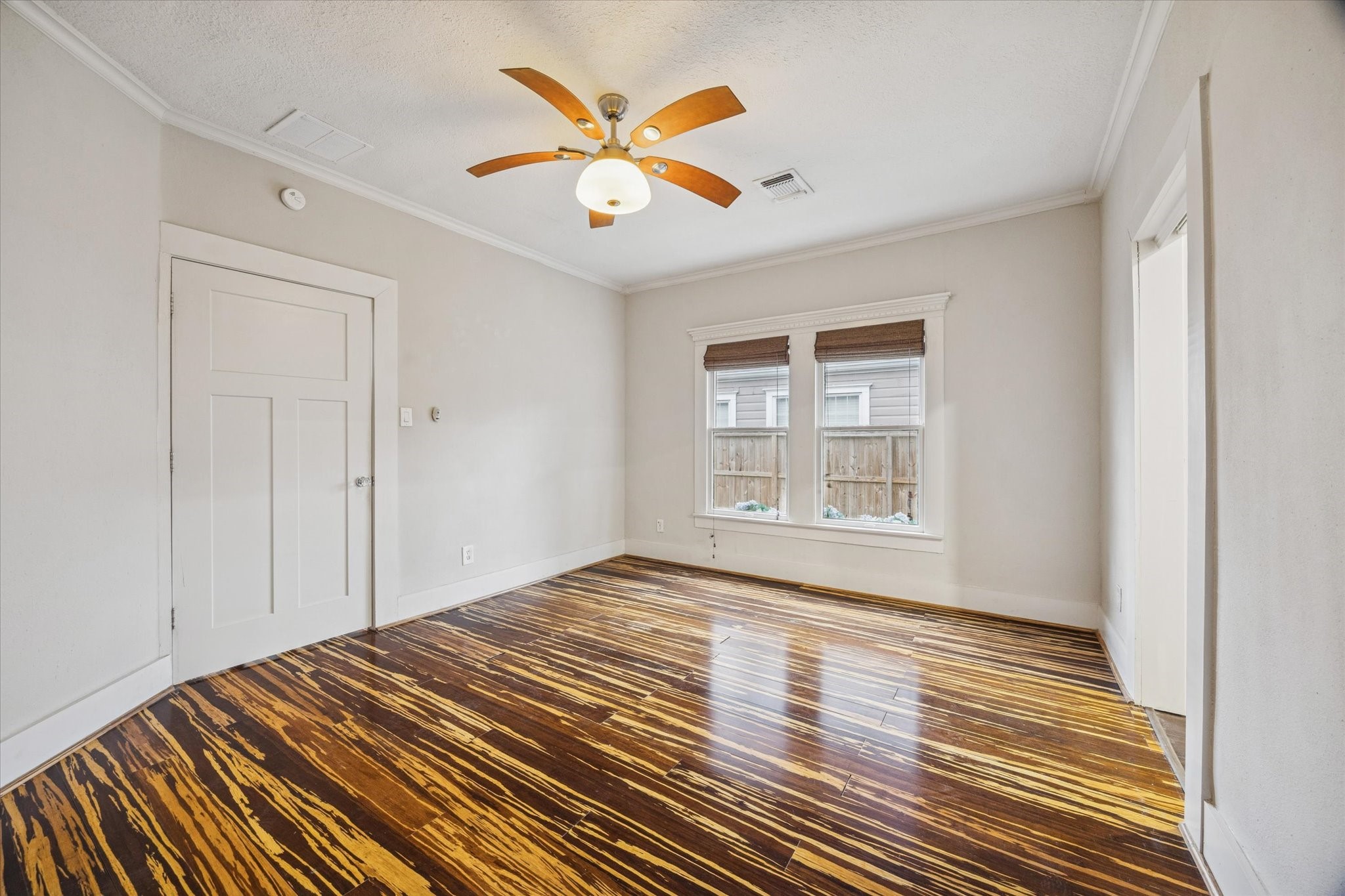 1124 Dunbar Street Houston, TX 77009 - Photo 15 of 21 Primary bedroom features hardwoods, a ceiling fan and large windows