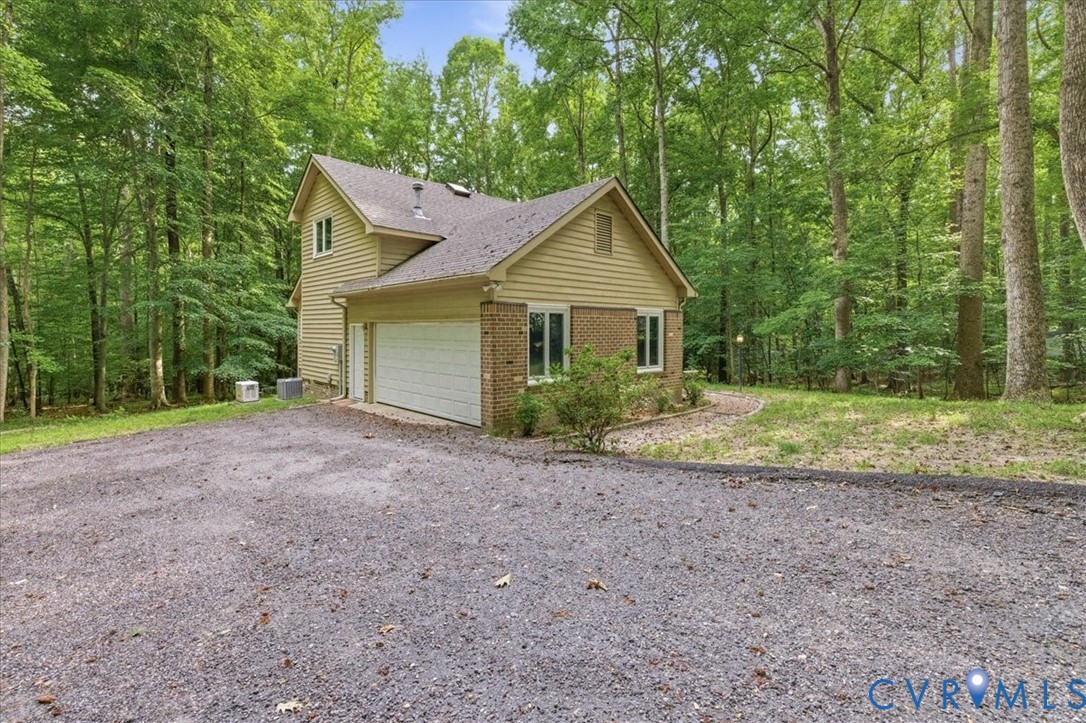 4099 Doe Run Road Hopewell, VA 23860 - Photo 3 of 36 Wooded exterior with tan siding and brick accents