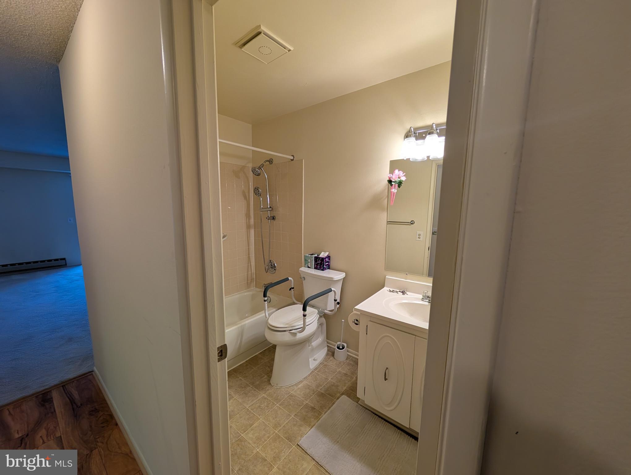 15401 Bassett Lane, Unit 452E Silver Spring, MD 20906 - Photo 16 of 26 a bathroom with a toilet sink and a mirror