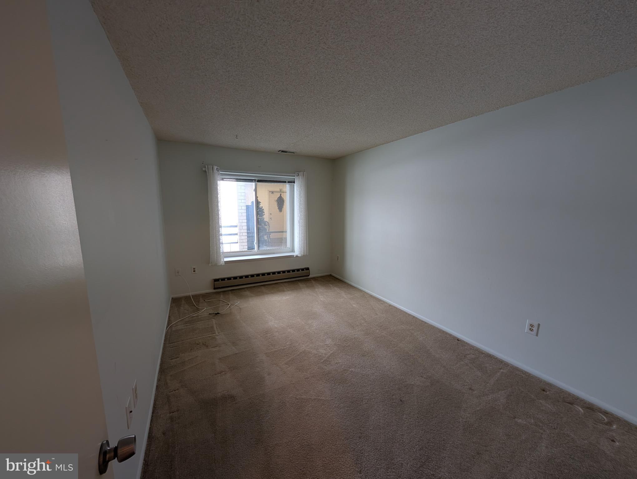 15401 Bassett Lane, Unit 452E Silver Spring, MD 20906 - Photo 9 of 26 an empty room with a windows and closet