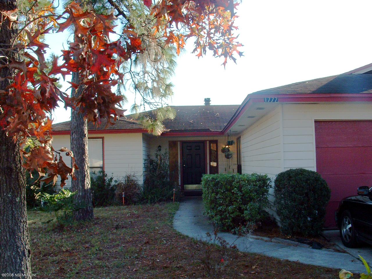 a backyard of a house with plants and trees