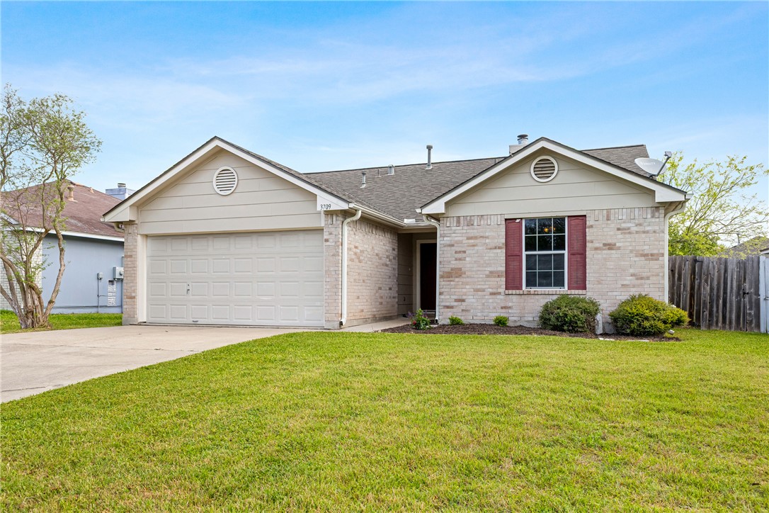 3709 Springfield Drive College Station, TX 77845 - Photo 2 of 23 a front view of a house with a yard and garage