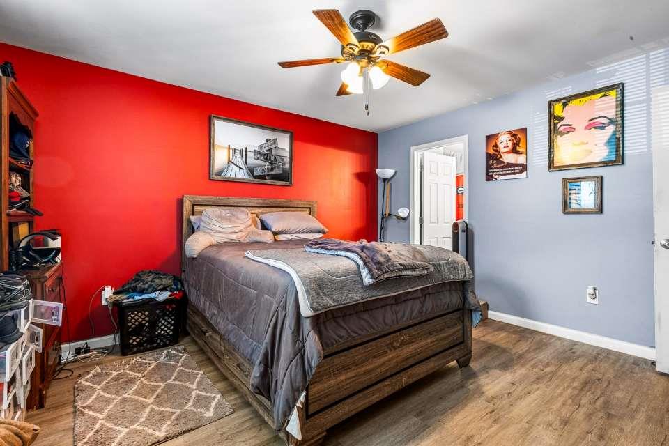 281 Northwinds Boulevard Carrollton, GA 30117 - Photo 13 of 15 a bedroom with a bed and a chandelier