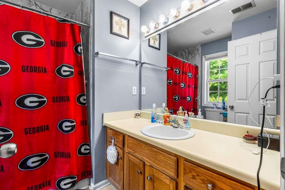 281 Northwinds Boulevard Carrollton, GA 30117 - Photo 15 of 15 a bathroom with a sink and a mirror