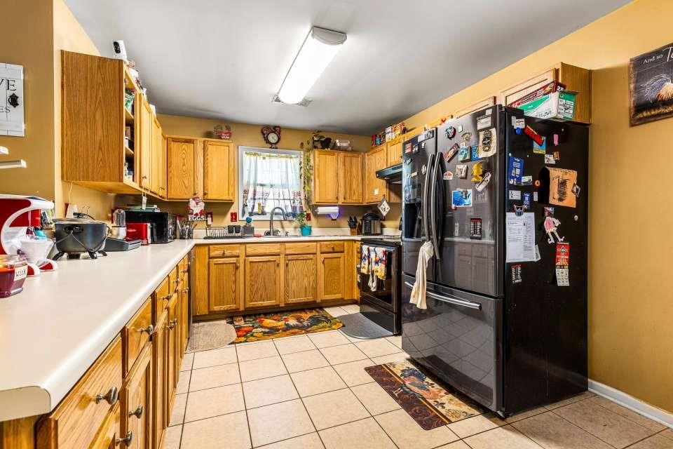 281 Northwinds Boulevard Carrollton, GA 30117 - Photo 5 of 15 a kitchen with a sink a counter top space and cabinets