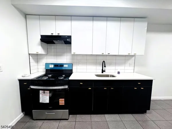 a kitchen with a sink and cabinets