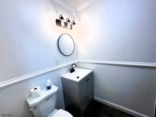 a bathroom with a sink mirror and toilet