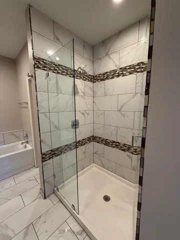 a bathroom with a shower and a bathtub