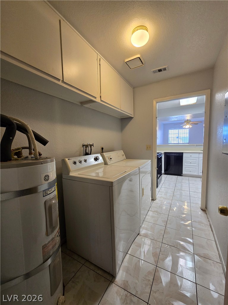 6750 Del Rey Avenue, Unit 133 Las Vegas, NV 89146 - Photo 28 of 34 Functional laundry space with overhead cabinetry and tile flooring.