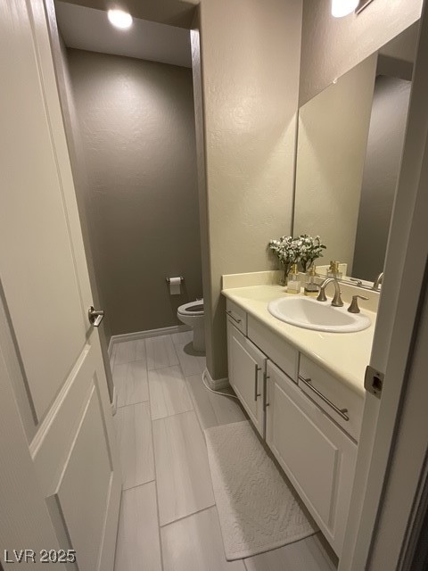 Undisclosed Address Henderson, NV 89011 - Photo 15 of 30 Downstairs' haff bath featuring vanity, a textured wall, and light tile patterned floors