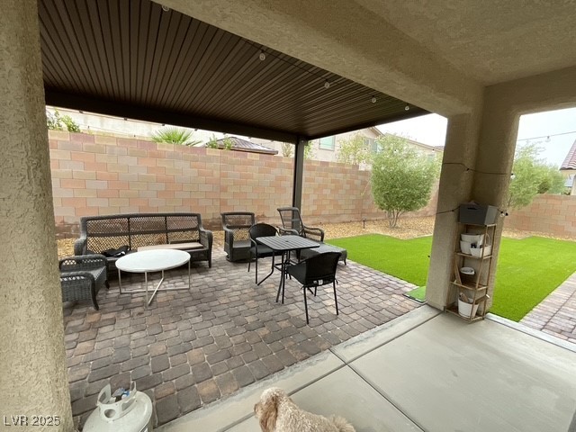 Undisclosed Address Henderson, NV 89011 - Photo 16 of 30 Fenced backyard with a patio area