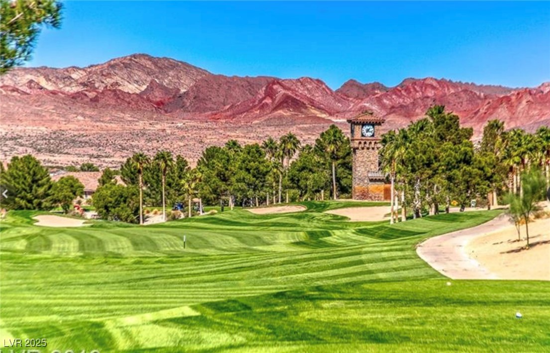 Undisclosed Address Henderson, NV 89011 - Photo 21 of 30 View of property's community with golf course view, a mountain view, and a lawn