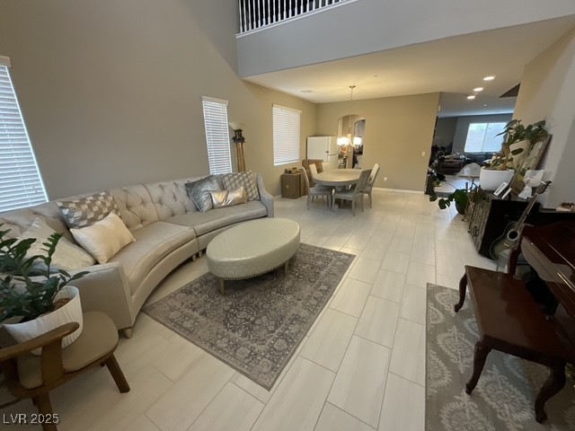 Undisclosed Address Henderson, NV 89011 - Photo 4 of 30 Living area with tall and high tall ceiling with beautiful spacious entry with a chandelier, recessed lighting