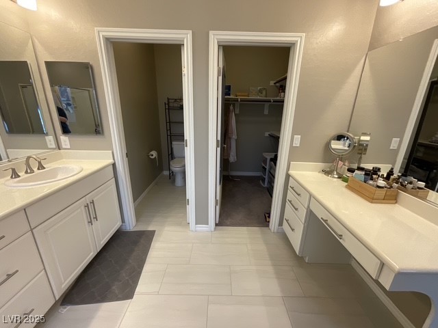Undisclosed Address Henderson, NV 89011 - Photo 6 of 30 Primary suite Bathroom featuring a spacious closet, vanity, and light tile patterned floors