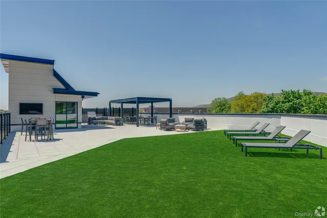 a view of livingroom with furniture and kitchen view