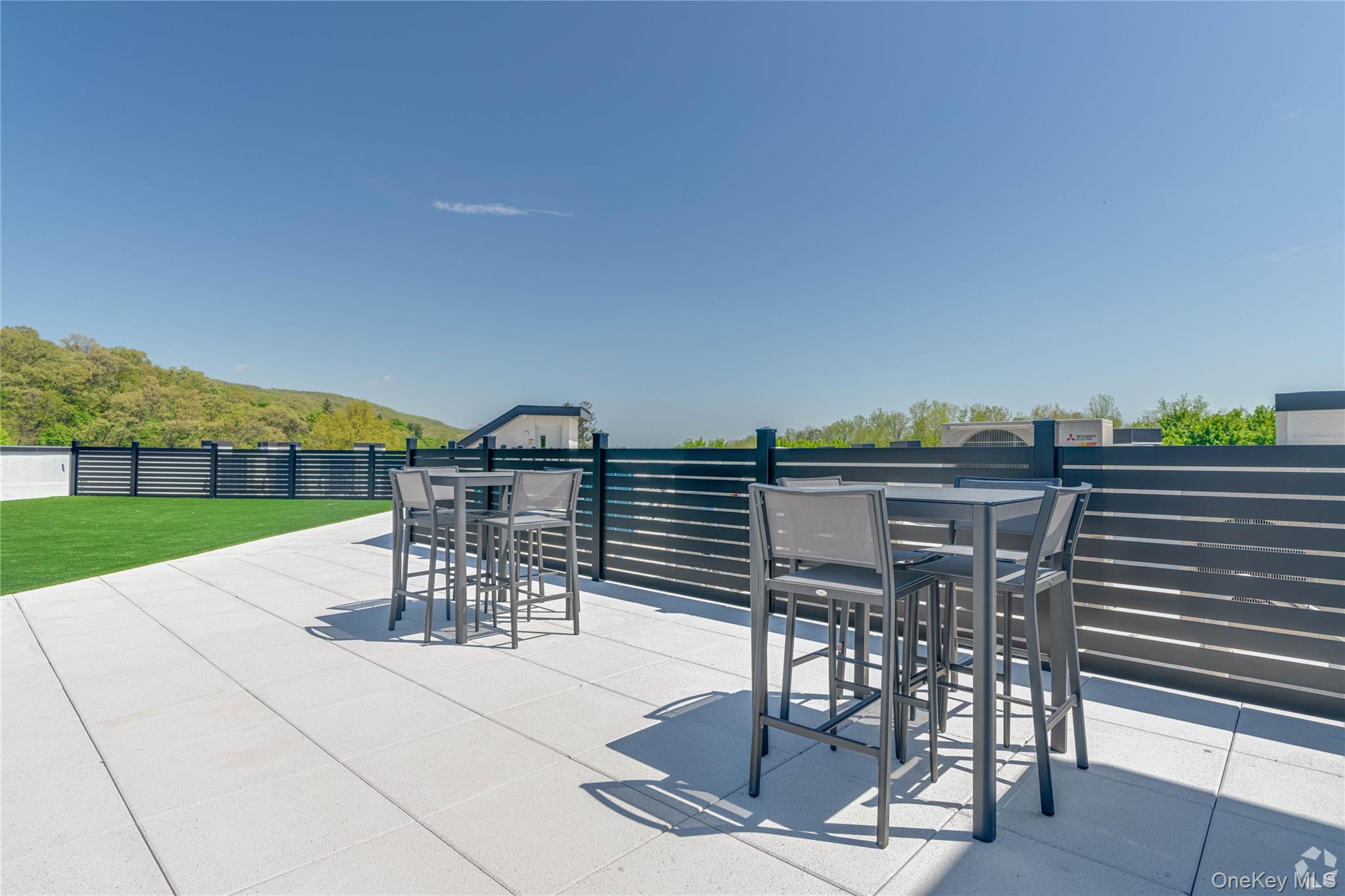 15 Washington Avenue, Unit 311 Suffern, NY 10901 - Photo 26 of 31 a view of a patio with a table and chairs