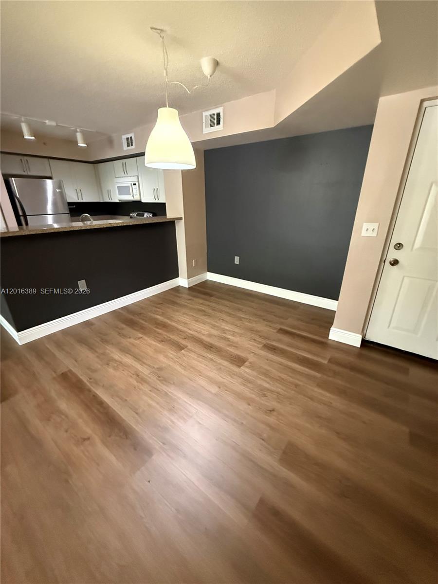 2113 Renaissance Boulevard, Unit 203 Miramar, FL 33025 - Photo 7 of 19 a view of kitchen and wooden floor