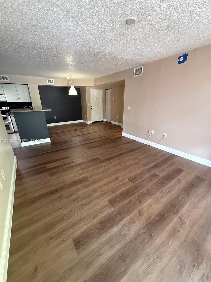 2113 Renaissance Boulevard, Unit 203 Miramar, FL 33025 - Photo 9 of 19 a view of empty room with wooden floor