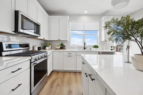 a kitchen with cabinets a sink and appliances