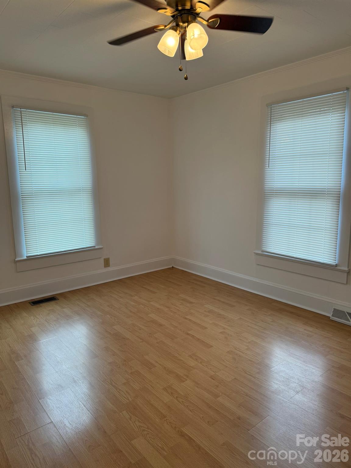 108 Fletcher Street Morganton, NC 28655 - Photo 14 of 29 an empty room with wooden floor fan and windows