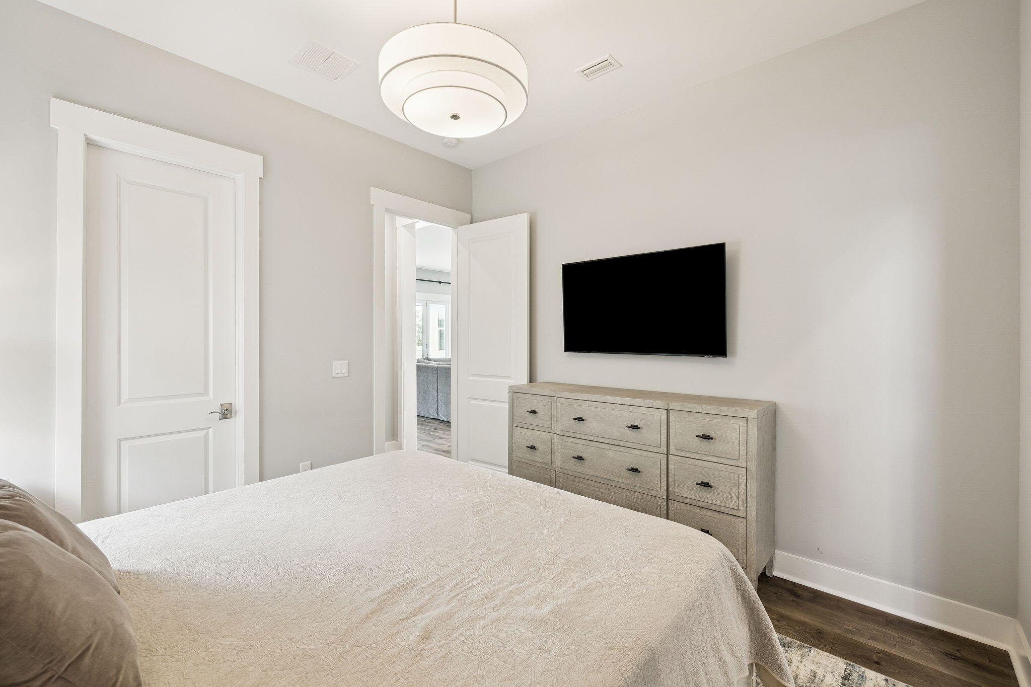 70 River Rise Way Inlet Beach Inlet Beach, FL 32461 - Photo 27 of 59 a bedroom with a bed and a flat tv screen on dresser