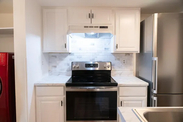 a kitchen with stainless steel appliances a stove and a refrigerator