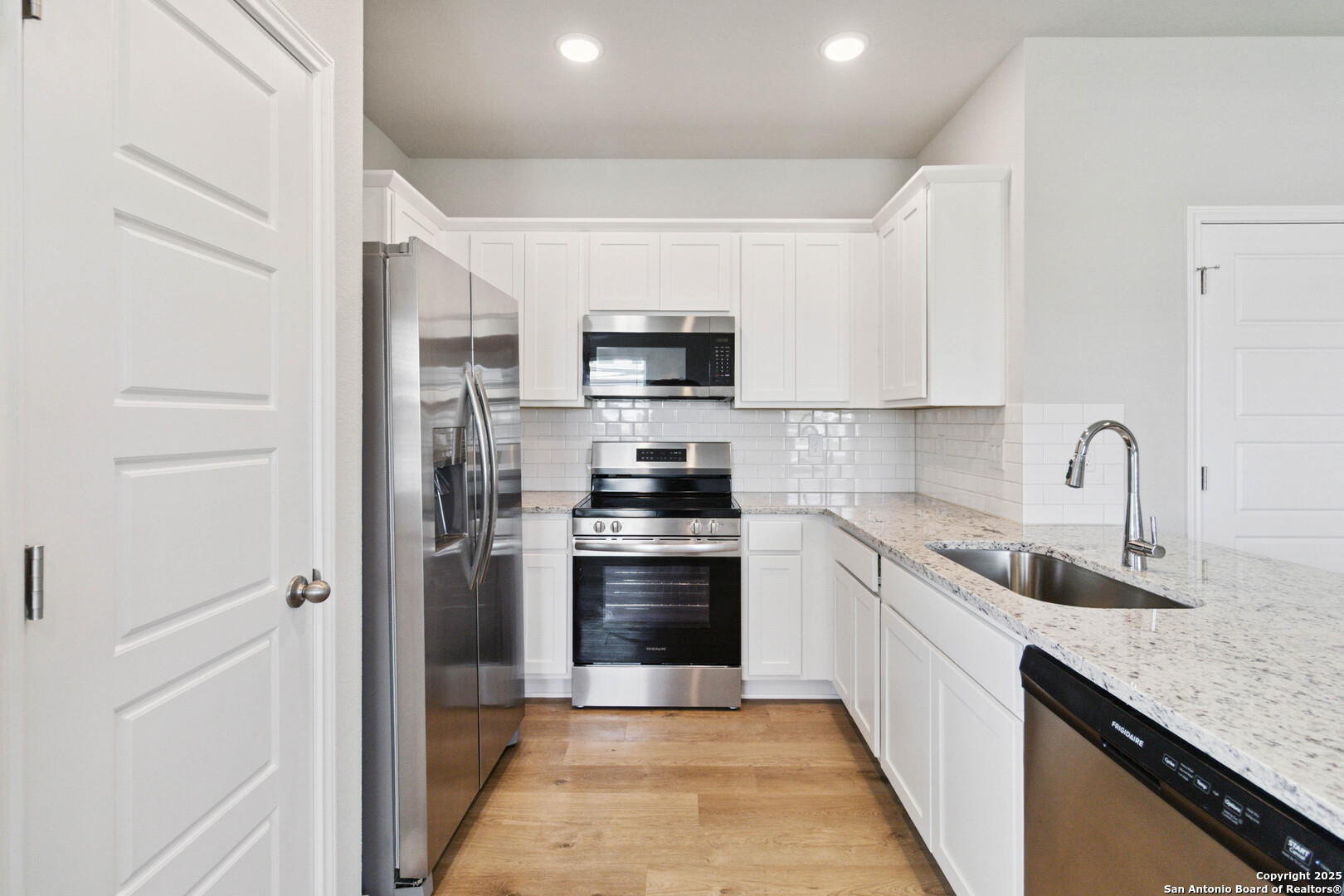 5406 Devils Gate Converse, TX 78109 - Photo 11 of 28 a kitchen with stainless steel appliances granite countertop a refrigerator a stove and a sink