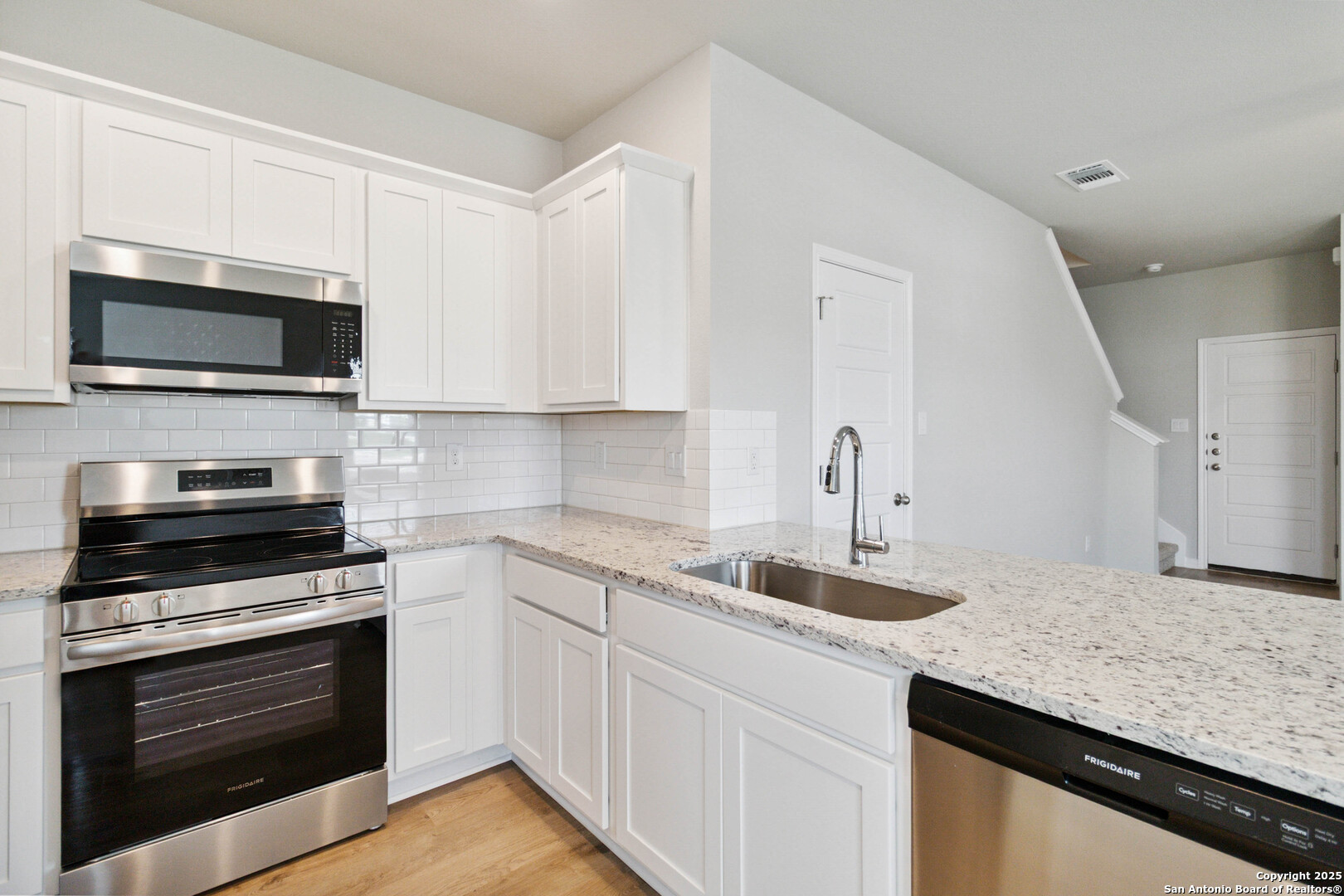 5406 Devils Gate Converse, TX 78109 - Photo 12 of 28 a kitchen with granite countertop a sink and stainless steel appliances