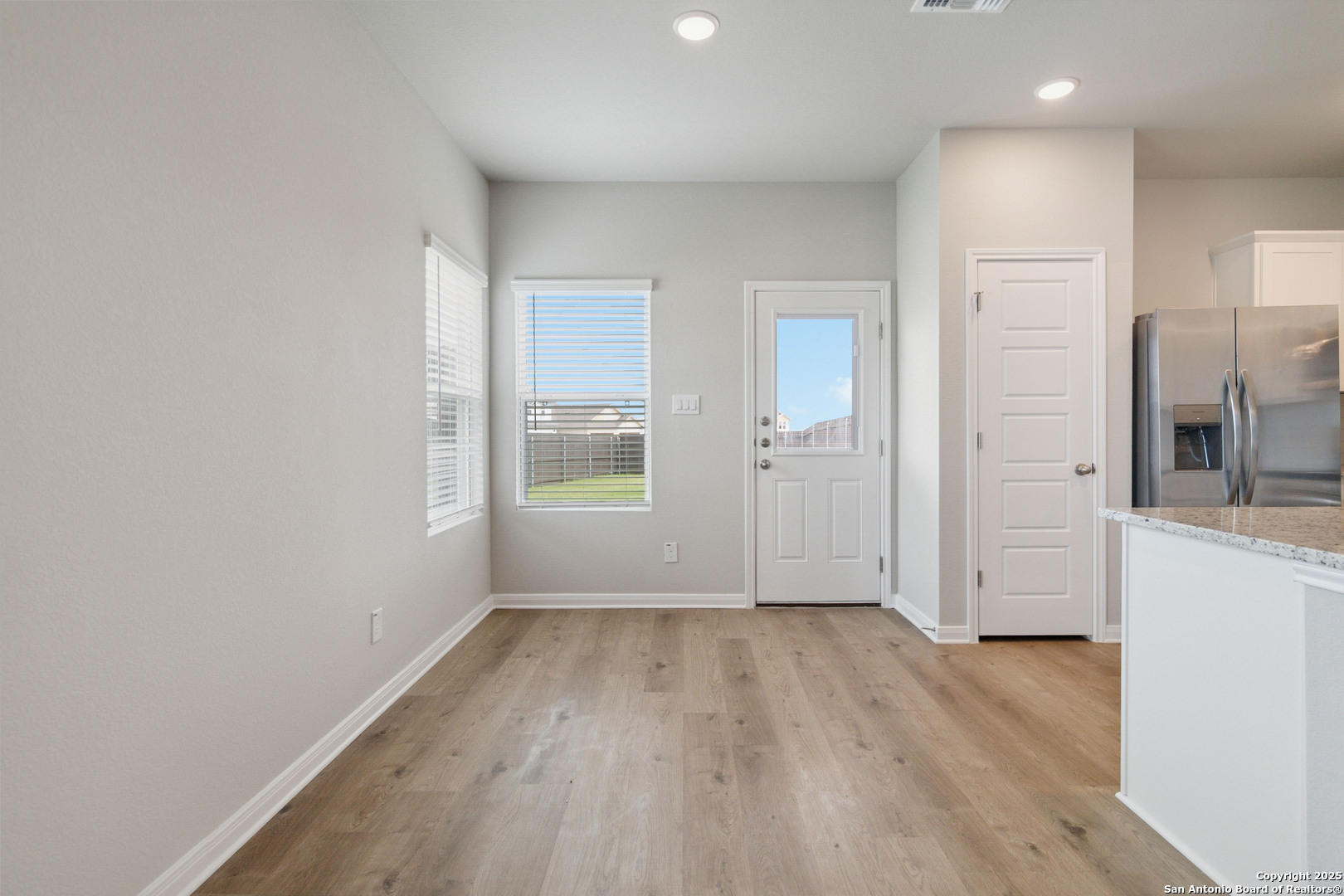 5406 Devils Gate Converse, TX 78109 - Photo 14 of 28 wooden floor in an empty room with a window