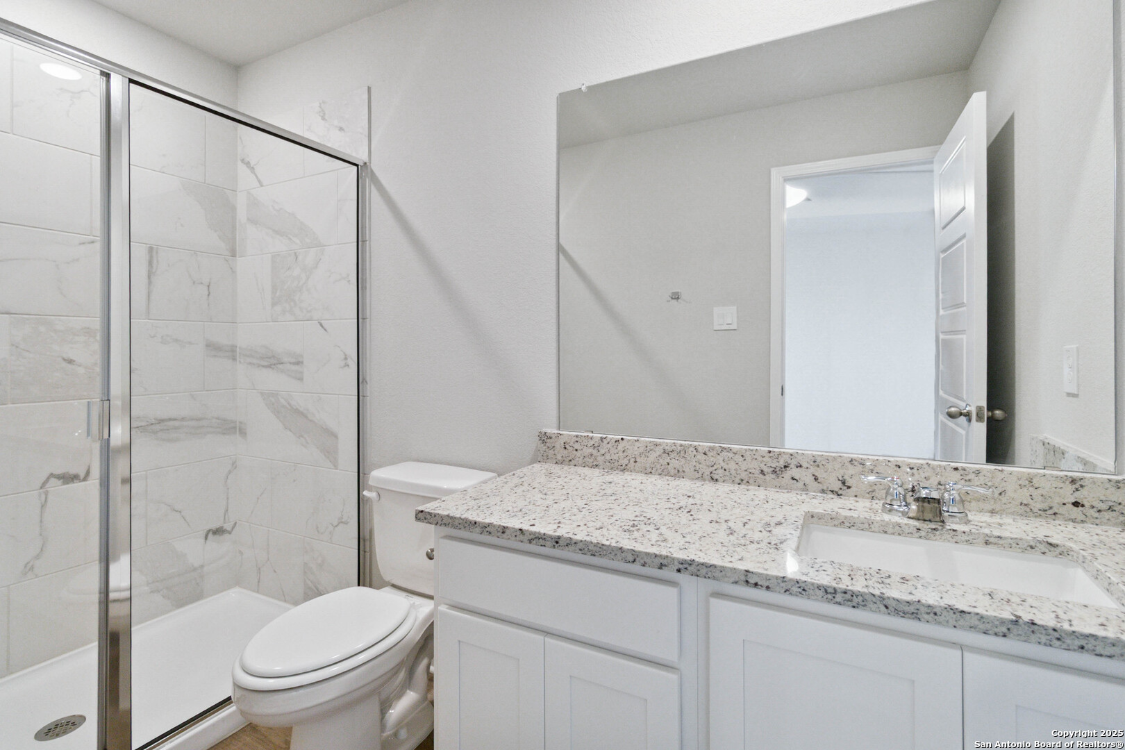 5406 Devils Gate Converse, TX 78109 - Photo 17 of 28 a bathroom with a granite countertop sink a toilet and shower