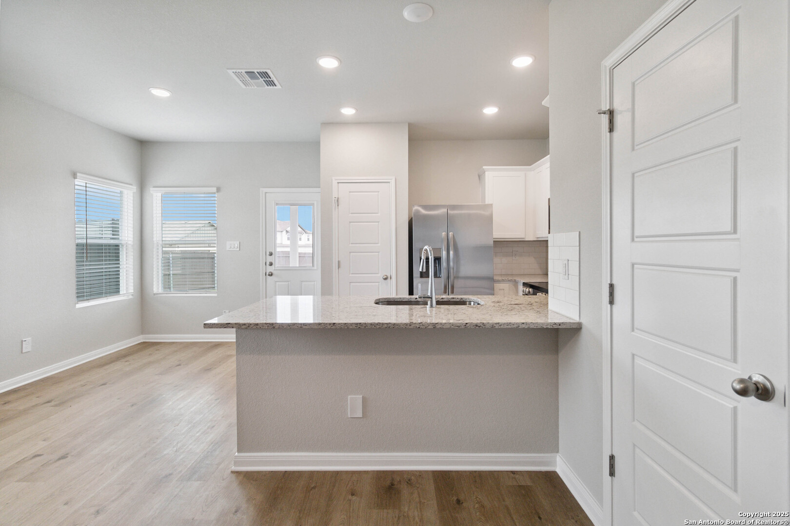 5406 Devils Gate Converse, TX 78109 - Photo 9 of 28 a view of kitchen with center island and wooden floor