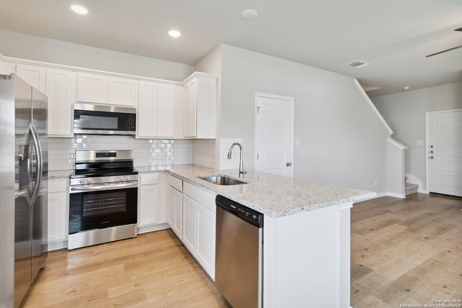 5406 Devils Gate Converse, TX 78109 - Photo 10 of 28 a kitchen with granite countertop a sink and stainless steel appliances