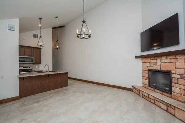 a view of kitchen and fireplace with empty space