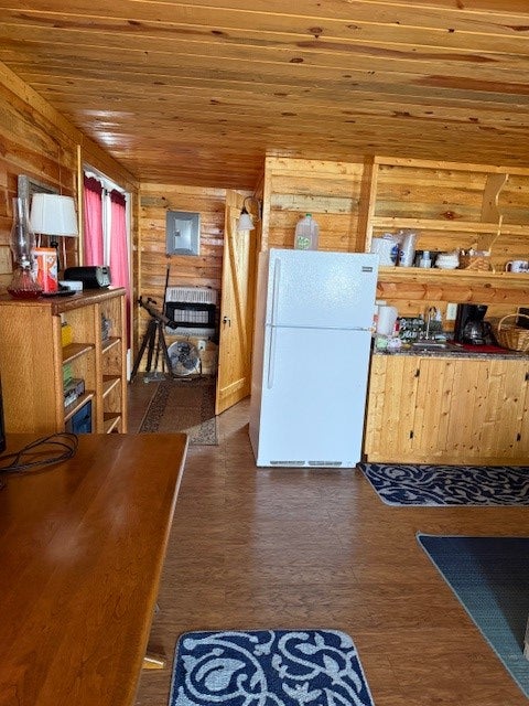 Nhn Canal Road Shawmut, MT 59078 - Photo 6 of 16 Kitchen featuring white refrigerator, wooden walls, heating unit, dark wood-style flooring, and wood ceiling