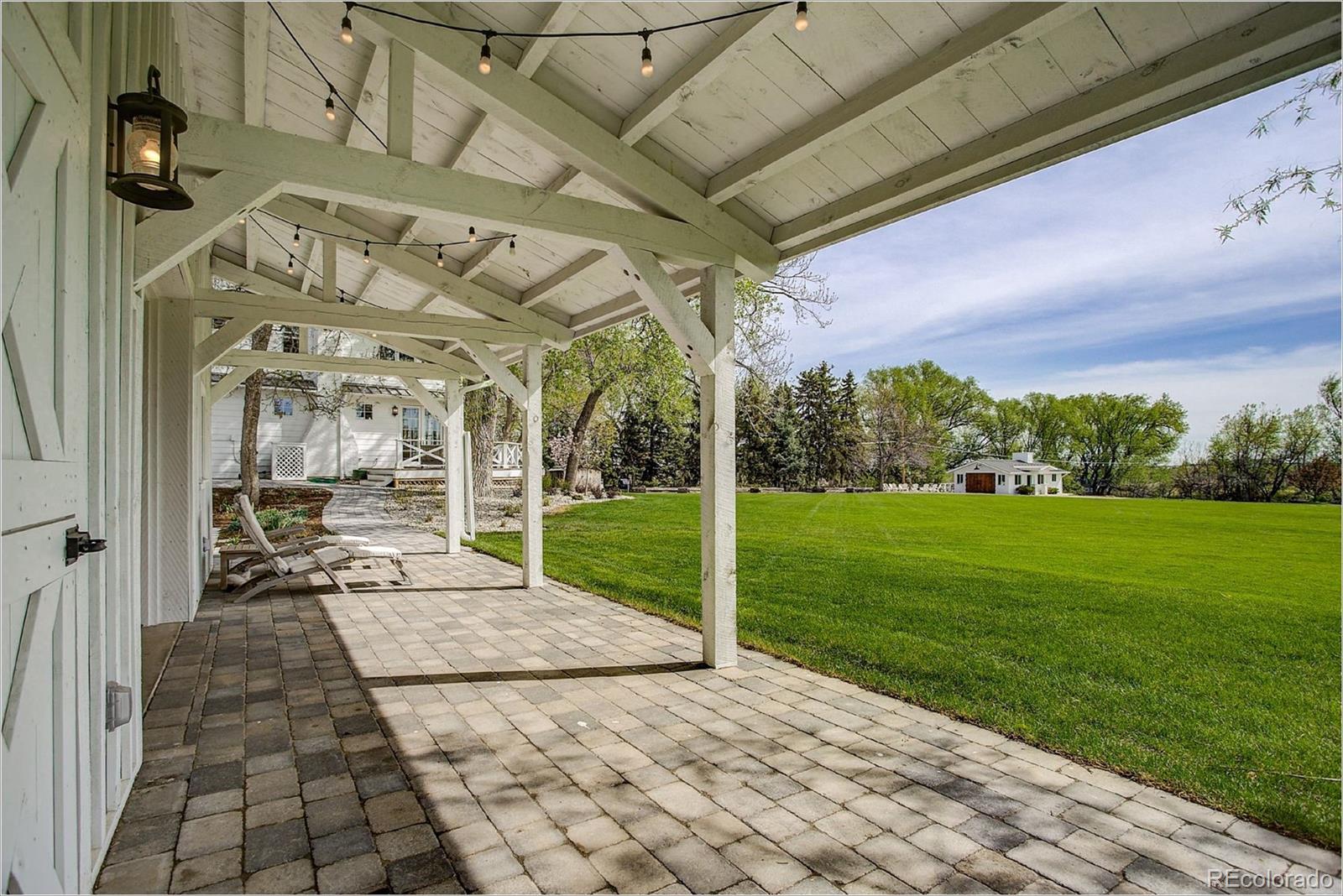 10261 Arapahoe Road Lafayette, CO 80026 - Photo 12 of 35 a view of a house with backyard and porch