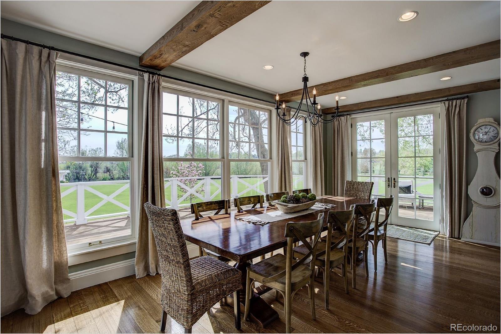 10261 Arapahoe Road Lafayette, CO 80026 - Photo 19 of 35 a view of a dining room with furniture window and wooden floor
