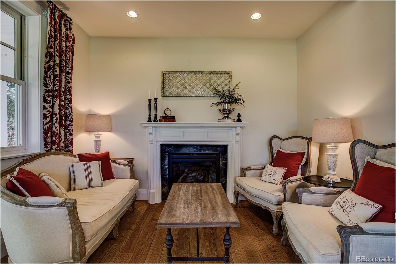 10261 Arapahoe Road Lafayette, CO 80026 - Photo 20 of 35 a living room with furniture and a fireplace