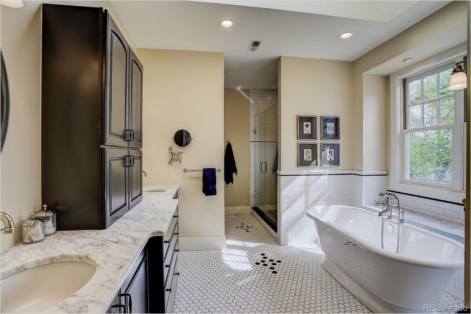 10261 Arapahoe Road Lafayette, CO 80026 - Photo 25 of 35 a bathroom with a granite countertop sink mirror and shower