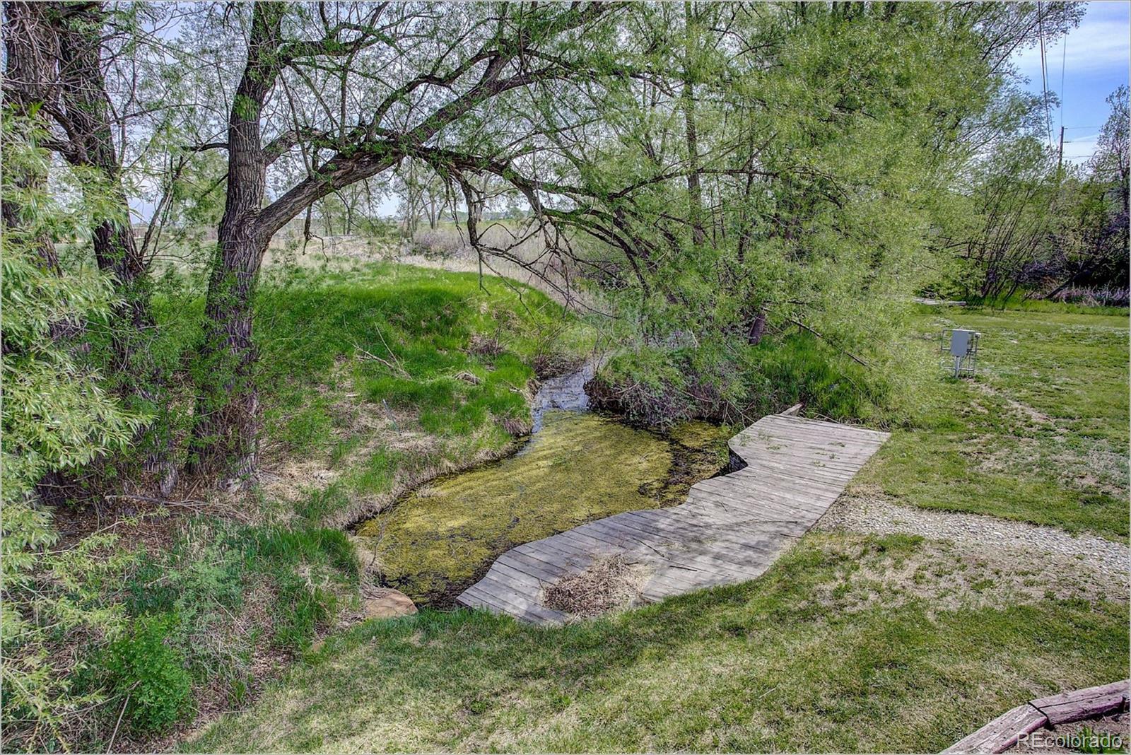 10261 Arapahoe Road Lafayette, CO 80026 - Photo 34 of 35 a backyard of a house with a yard and outdoor seating