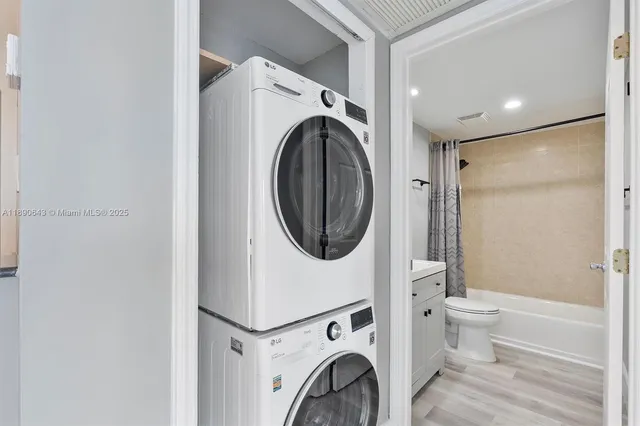 a view of a hallway with washer and dryer