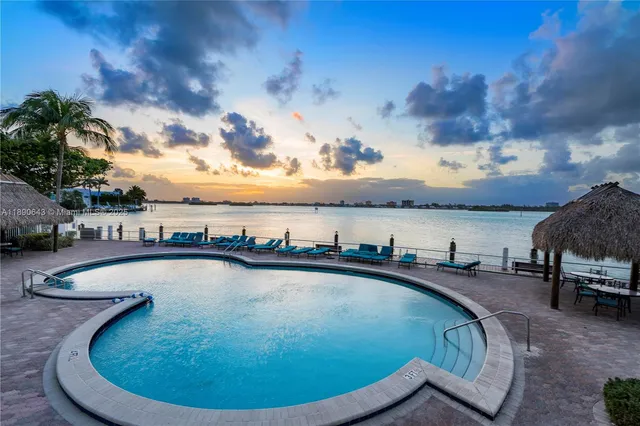 a view of a swimming pool with outdoor seating