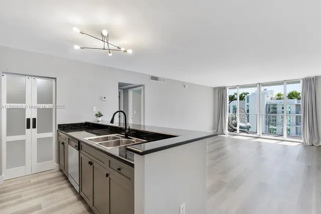 a kitchen that has a stove and a wooden floor