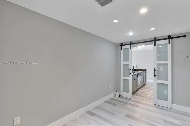a view of a kitchen with a sink and refrigerator
